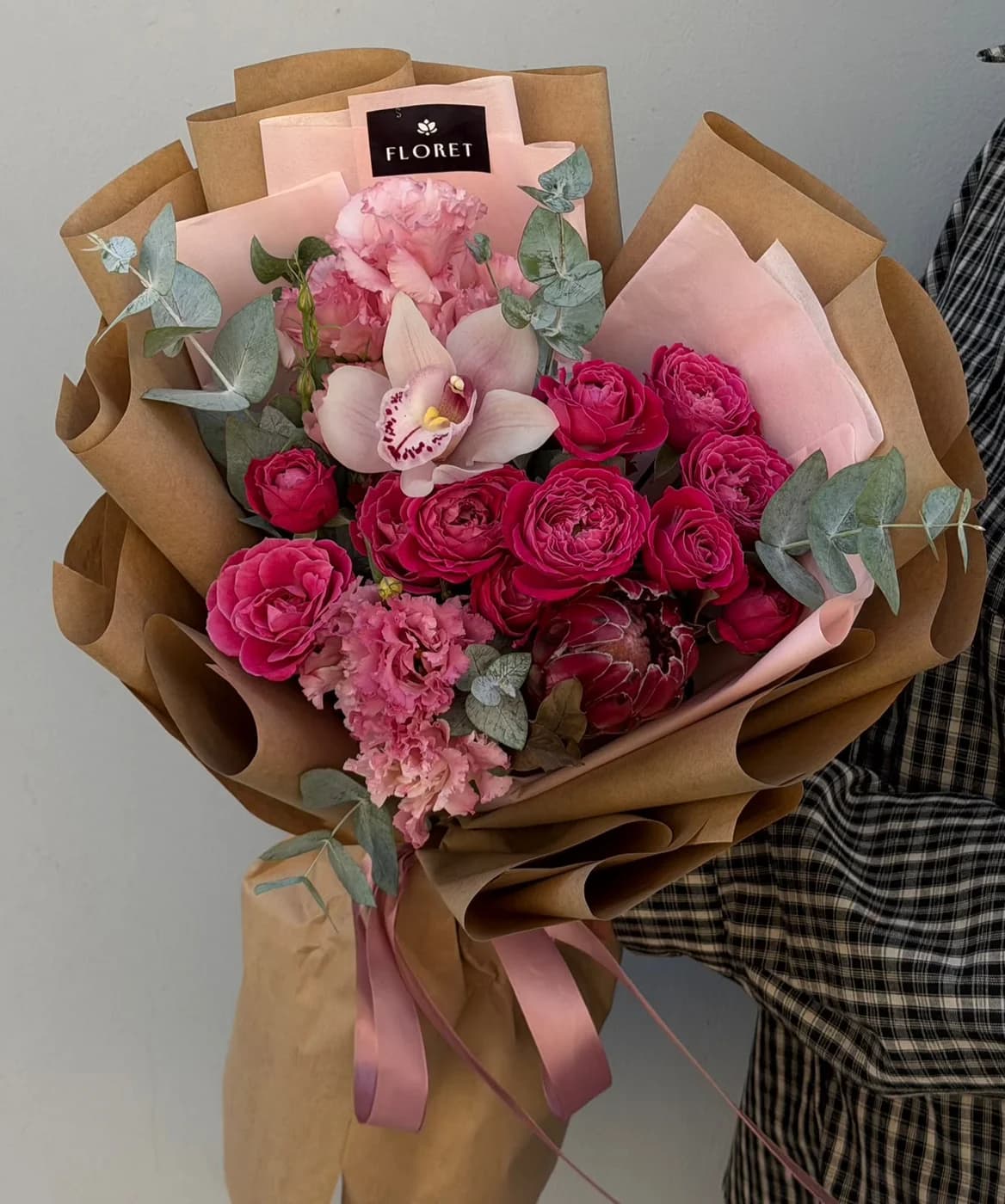 Mixed bouquet of Purple Silva spray roses, protea, lisianthus, and orchids