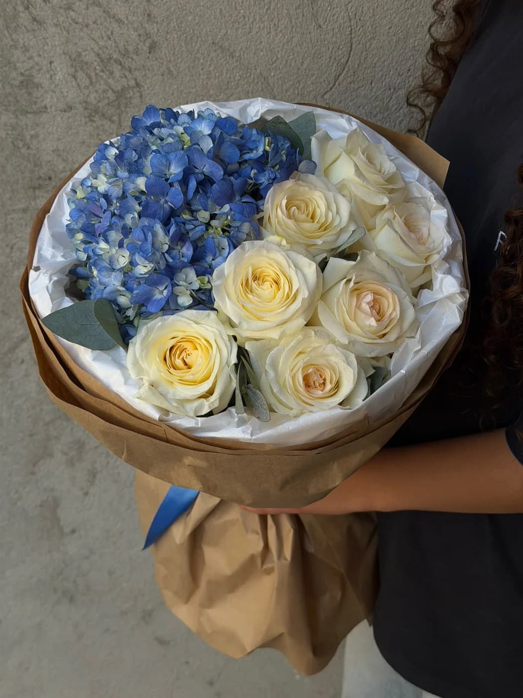 Duo bouquet of Candle Light roses and blue hydrangea.