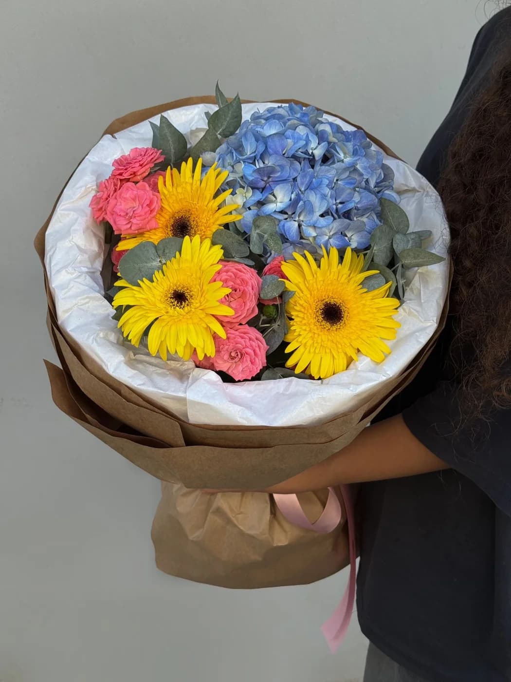 Mixed bouquet made with Barbados spray roses, blue hydrangea, and gerbera flowers.
