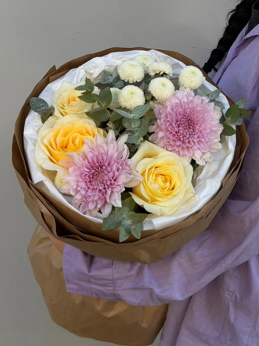 A mix bouquet made with candle light roses, pink chrysanthemum, and white dubki flowers